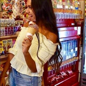 Off shoulder yellow shirt.